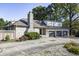 House exterior features stone facade, triple garage, and landscaping at 6502 Allisonville Rd, Indianapolis, IN 46220