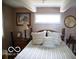 Cozy bedroom with wood bed frame and striped bedding at 7477 Honey Locust Dr, Nineveh, IN 46164