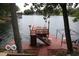 Elevated lakefront deck with stairs and seating area at 7477 Honey Locust Dr, Nineveh, IN 46164