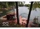 Lakefront deck with a covered patio and lake views at 7477 Honey Locust Dr, Nineveh, IN 46164