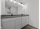 Modern bathroom with double vanity, dark countertop, and unique lighting at 4231 Barrel Ln, Westfield, IN 46062