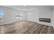 Spacious living room with large windows, fireplace, and wood-look flooring at 4231 Barrel Ln, Westfield, IN 46062