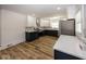 Modern kitchen featuring white and dark blue cabinetry, and a stainless steel refrigerator at 1666 Union St, Indianapolis, IN 46225