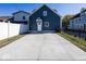 Rear view of blue house with private driveway and fence at 1666 Union St, Indianapolis, IN 46225