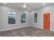 Bright living room featuring hardwood floors and a vibrant orange door at 838 N Tacoma Ave, Indianapolis, IN 46201