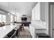 Kitchen features white cabinets, quartz countertops, and a breakfast bar at 6429 Flag Stop Dr, Whitestown, IN 46075