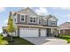 Two story home with gray siding and brick accents, two-car garage at 6429 Flag Stop Dr, Whitestown, IN 46075