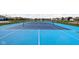 Blue tennis court with net and surrounding fence at 6429 Flag Stop Dr, Whitestown, IN 46075