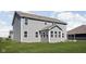 Two story house with gray siding, sunroom, and landscaped yard at 6429 Flag Stop Dr, Whitestown, IN 46075