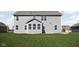 Gray sided two-story house with a sunroom and grassy backyard at 6429 Flag Stop Dr, Whitestown, IN 46075