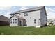 Two-story house with gray siding, sunroom and grassy backyard at 6429 Flag Stop Dr, Whitestown, IN 46075