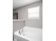 Relaxing bathroom featuring a large soaking tub and window at 6429 Flag Stop Dr, Whitestown, IN 46075
