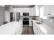 Modern kitchen boasts white cabinets, stainless steel appliances, and quartz countertops at 6429 Flag Stop Dr, Whitestown, IN 46075