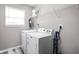Bright laundry room features washer, dryer, and shelving at 6429 Flag Stop Dr, Whitestown, IN 46075