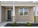 Brick front porch with black door and white columns at 6429 Flag Stop Dr, Whitestown, IN 46075