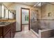Modern bathroom with walk-in shower and granite vanity at 6470 Around The Hills Rd, Indianapolis, IN 46226