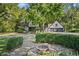 Tudor style home with stone exterior and landscaping at 6470 Around The Hills Rd, Indianapolis, IN 46226
