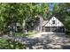 Tudor style home with stone exterior and landscaping at 6470 Around The Hills Rd, Indianapolis, IN 46226