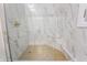 Large walk-in shower with marble tile and hexagon floor at 6470 Around The Hills Rd, Indianapolis, IN 46226