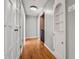 Bright hallway with hardwood floors and built-in shelving at 6470 Around The Hills Rd, Indianapolis, IN 46226