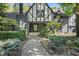 Charming Tudor style home with manicured landscaping and walkway at 6470 Around The Hills Rd, Indianapolis, IN 46226