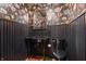 Stylish powder room with black vanity and floral wallpaper at 6470 Around The Hills Rd, Indianapolis, IN 46226