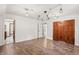 Bright bedroom with hardwood floors and access to another room at 6470 Around The Hills Rd, Indianapolis, IN 46226