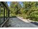 Large, stone patio with a view of the backyard and surrounding trees at 6470 Around The Hills Rd, Indianapolis, IN 46226