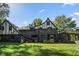 Tudor style home with stone exterior and landscaped yard at 6470 Around The Hills Rd, Indianapolis, IN 46226
