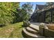 Stone patio with steps leading down to grassy backyard, adjacent to home at 6470 Around The Hills Rd, Indianapolis, IN 46226