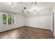 Spacious bedroom with hardwood floors and large window at 6470 Around The Hills Rd, Indianapolis, IN 46226