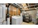 Basement laundry area with washer, dryer, and storage shelving at 1053 Millwood Ct # 3, Indianapolis, IN 46260