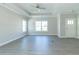 Bright living room with gray flooring, neutral walls, and a ceiling fan at 4435 W Preserve Pass, New Palestine, IN 46163
