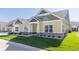 Two-story townhome with yellow siding, gray accents, and a two-car garage at 4435 W Preserve Pass, New Palestine, IN 46163