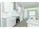 Modern kitchen with white cabinets, stainless steel appliances and quartz countertops at 4435 W Preserve Pass, New Palestine, IN 46163