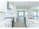 Modern kitchen with white cabinets, stainless steel appliances and quartz countertops at 4435 W Preserve Pass, New Palestine, IN 46163