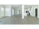 Open living room and kitchen with hardwood floors and white cabinets at 4435 W Preserve Pass, New Palestine, IN 46163