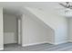 Spacious bonus room with grey carpet, sloped ceilings, and window at 4435 W Preserve Pass, New Palestine, IN 46163