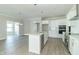 Modern kitchen with white cabinets, stainless steel appliances, and a large island at 4435 W Preserve Pass, New Palestine, IN 46163