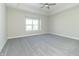 Spacious bedroom with grey carpet, ceiling fan, and large window at 4435 W Preserve Pass, New Palestine, IN 46163