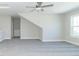 Spacious bonus room with grey carpet, sloped ceilings, and window at 4435 W Preserve Pass, New Palestine, IN 46163