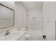 Clean bathroom with a bathtub, white vanity, and marble-look tile at 2843 Grandview Ln, Greenwood, IN 46143