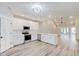 Modern kitchen with white cabinets, stainless steel appliances, and luxury vinyl plank flooring at 2843 Grandview Ln, Greenwood, IN 46143