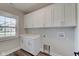 Laundry room with white cabinets, quartz countertop, and a window at 2843 Grandview Ln, Greenwood, IN 46143