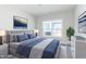 Bedroom with gray upholstered bed, blue bedding, and neutral decor at 4435 W Preserve Pass, New Palestine, IN 46163