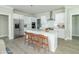 White kitchen with stainless steel appliances and island with seating at 4435 W Preserve Pass, New Palestine, IN 46163
