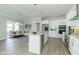 Modern white kitchen with stainless steel appliances and an island at 4435 W Preserve Pass, New Palestine, IN 46163