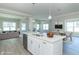 Open concept kitchen with island, white cabinets, and stainless steel appliances at 4435 W Preserve Pass, New Palestine, IN 46163