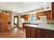 Simple kitchen with wood cabinets, a brick fireplace, and light wood floors at 9490 N 700 E, Indianapolis, IN 46259