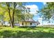 Charming one-story home with a front porch, surrounded by lush greenery at 9490 N 700 E, Indianapolis, IN 46259